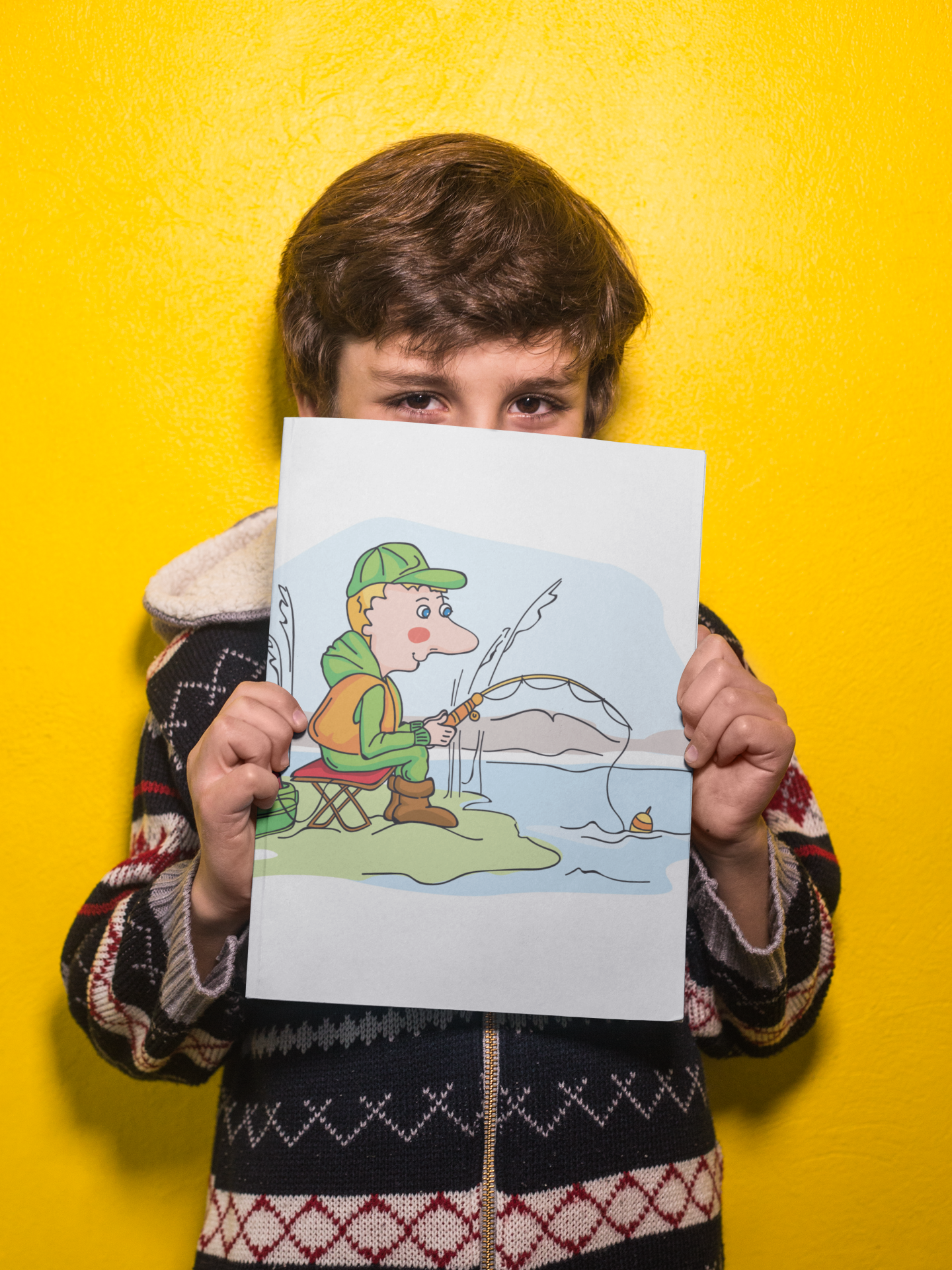 Boy holding a big book mockup against a yellow wall a19218  2 %d0%be%d0%be