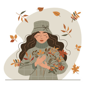 Autumn mood. A girl with a leaves bouquet.